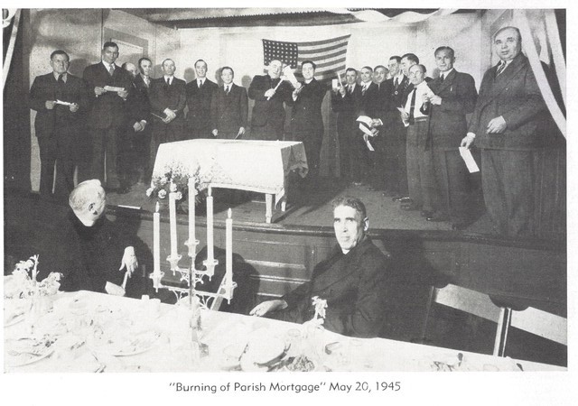 "Burning of the Parish Mortage" (Passaic, Holy Ascension parish) The man in front of the flag onstage holding the candle to the document is Archbishop Ioan (John) Teorodovych of the American Ukrainian Orthodox Church in the United States